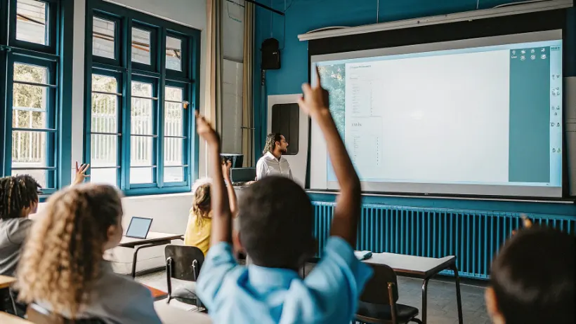 Students actively participating in educational interactive whiteboard games in modern classroom setting